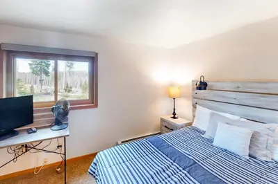 a bedroom with a bed and a desk with a computer at Timber Ridge 203 in Silverthorne