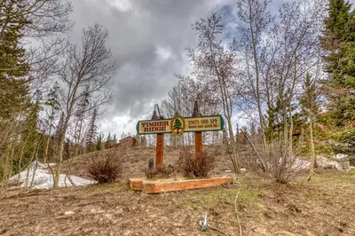 a sign in the middle of a field with trees at Timber Ridge 203 in Silverthorne