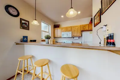a kitchen with two bar stools and a counter at Tarn Landing B7 in Frisco