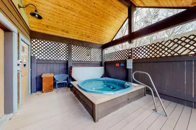 a jacuzzi tub in a building with a wooden ceiling at Tarn Landing B7 in Frisco