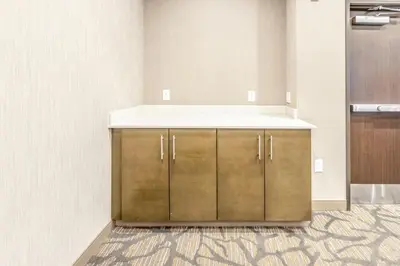 a kitchen with a counter with a sink at Hawthorn Extended Stay by Wyndham Loveland in Johnstown