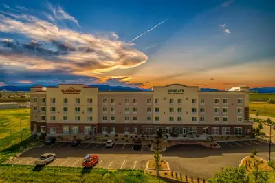 a hotel with a parking lot in front of it at Hawthorn Extended Stay by Wyndham Loveland in Johnstown