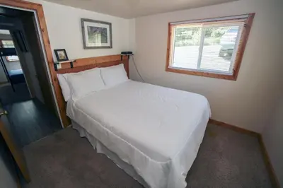 a white bed in a bedroom with a window at Ponderosa Lodge in Estes Park