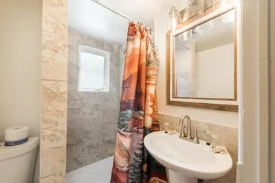 a bathroom with a sink and a toilet and a mirror at Ponderosa Lodge in Estes Park
