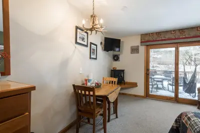 a dining room with a table and chairs and a dining room at Ponderosa Lodge in Estes Park