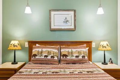 a bedroom with a bed with two lamps at Ponderosa Lodge in Estes Park
