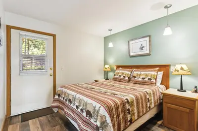 a bedroom with a large bed and a window at Ponderosa Lodge in Estes Park