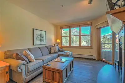 a living room with a couch and a coffee table at Cozy And Quaint 1 Bedroom Condo In The Heart Of River Run Village in Keystone