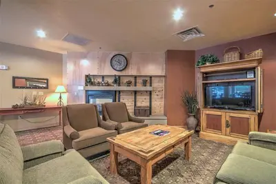 a living room with couches and a coffee table at Cozy And Quaint 1 Bedroom Condo In The Heart Of River Run Village in Keystone