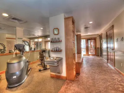 a room with a gym with a treadmill in it at 3 Bedroom Mountain View Condo In River Run Village Just 75 Yards From The Summit Express Gondola in Keystone