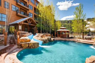 a pool in a yard with a gazebo at 3 Bedroom Mountain View Condo In River Run Village Just 75 Yards From The Summit Express Gondola in Keystone