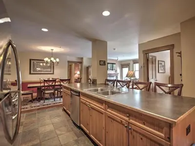 a kitchen with a sink and a dining room at 3 Bedroom Mountain View Condo In River Run Village Just 75 Yards From The Summit Express Gondola in Keystone