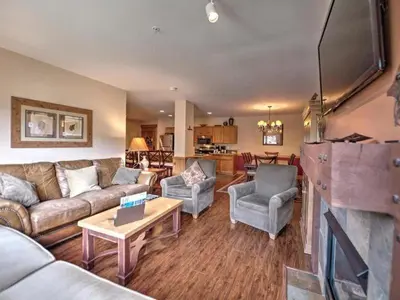 a living room with a couch and chairs and a tv at 3 Bedroom Mountain View Condo In River Run Village Just 75 Yards From The Summit Express Gondola in Keystone