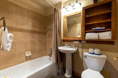 a bathroom with a sink and a toilet and a tub at 2311 Red Hawk Lodge Condo in Keystone