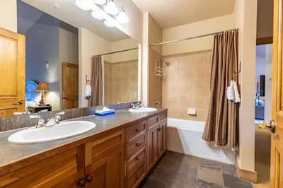 a bathroom with a sink and a tub and a shower at 2311 Red Hawk Lodge Condo in Keystone