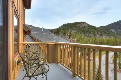 a balcony with two chairs and a view of a mountain at 2311 Red Hawk Lodge Condo in Keystone