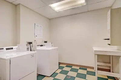 a laundry room with white appliances and a checkered floor at 2311 Red Hawk Lodge Condo in Keystone