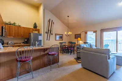 a kitchen and living room with a couch and a table at 2311 Red Hawk Lodge Condo in Keystone