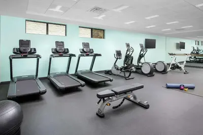 a gym with several exercise equipment in a room at Homewood Suites By Hilton Denver Airport Tower Road in Denver