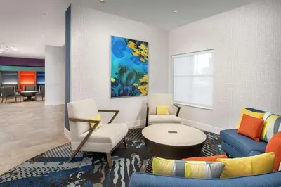 a living room with a couch and chairs and a table at Homewood Suites By Hilton Denver Airport Tower Road in Denver