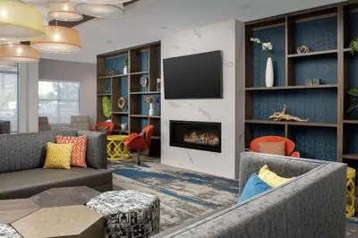 a living room with two couches and a fireplace at Homewood Suites By Hilton Denver Airport Tower Road in Denver