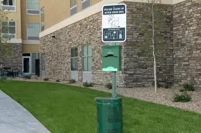 a trash can with a street sign in front of a building at Tru By Hilton Denver Airport Tower Road in Denver
