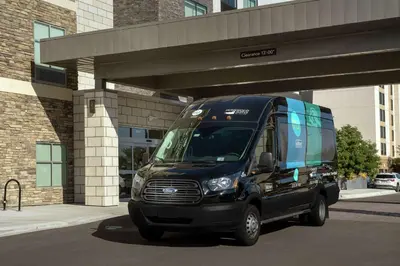 a black van parked in front of a building at Tru By Hilton Denver Airport Tower Road in Denver