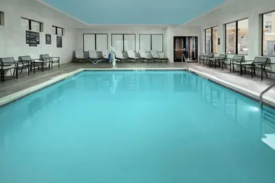 a swimming pool with blue water in a building at Tru By Hilton Denver Airport Tower Road in Denver