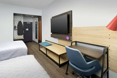a hotel room with a desk and a tv at Tru By Hilton Denver Airport Tower Road in Denver