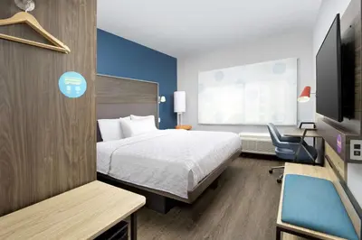a hotel room with a bed and a chair at Tru By Hilton Denver Airport Tower Road in Denver