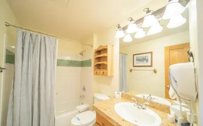 a bathroom with a sink and a toilet and a tub at 2 Bedroom Colorado Mountain Vacation Rental In River Run Village With Hot Tub Access And Walking Distance To Ski in Keystone