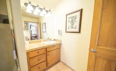 a bathroom with a sink and a mirror at 2 Bedroom Colorado Mountain Vacation Rental In River Run Village With Hot Tub Access And Walking Distance To Ski in Keystone