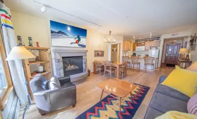 a living room with a couch and a fireplace at 2 Bedroom Colorado Mountain Vacation Rental In River Run Village With Hot Tub Access And Walking Distance To Ski in Keystone