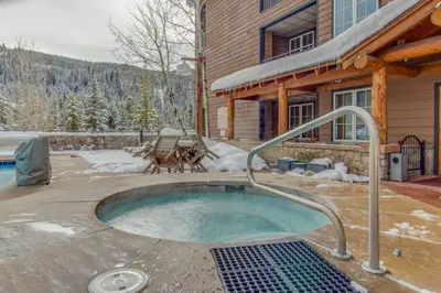 a hot tub in a yard in front of a house at 1 Bedroom Plus Murphy Mountain Condo In River Run Village With Hot Tub Access And Walking Distance To Ski in Keystone