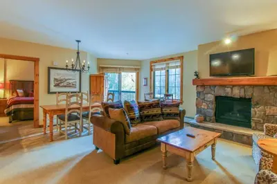 a living room with a couch and a fireplace at 1 Bedroom Plus Murphy Mountain Condo In River Run Village With Hot Tub Access And Walking Distance To Ski in Keystone