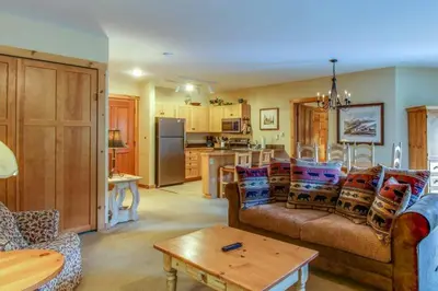 a living room with a couch and a kitchen at 1 Bedroom Plus Murphy Mountain Condo In River Run Village With Hot Tub Access And Walking Distance To Ski in Keystone