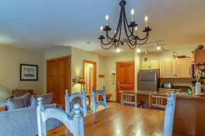 a kitchen and dining room with a table and a chandelier at 1 Bedroom Plus Murphy Mountain Condo In River Run Village With Hot Tub Access And Walking Distance To Ski in Keystone