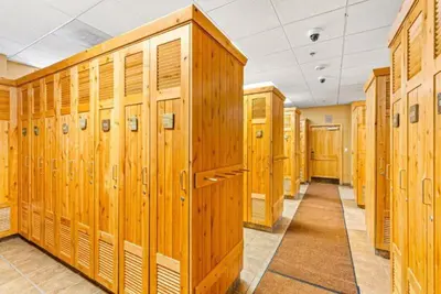 a row of wooden lockers in a locker room at 1 Bedroom Mountain Chic Condo In River Run Village Just A Short Walk To Shopping, Dining, And Skiing in Keystone
