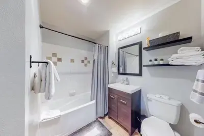 a bathroom with a toilet and a tub and a sink at 1 Bedroom Mountain Chic Condo In River Run Village Just A Short Walk To Shopping, Dining, And Skiing in Keystone