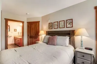 a bedroom with a large white bed and a bathroom at 1 Bedroom Colorado Mountain Vacation Rental In River Run Village With Convenient Access To Ski Slopes in Snake River Health Services Incorporated Heliport
