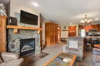 a living room with a fireplace with a flat screen tv at 1 Bedroom Colorado Mountain Vacation Rental In River Run Village With Convenient Access To Ski Slopes in Snake River Health Services Incorporated Heliport