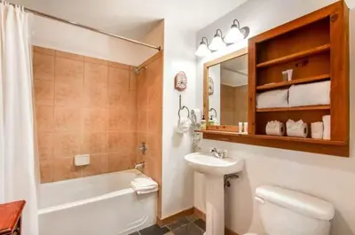a bathroom with a sink and a toilet and a bath tub at 1 Bedroom Colorado Mountain Vacation Rental In River Run Village With Convenient Access To Ski Slopes in Snake River Health Services Incorporated Heliport