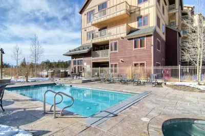 a swimming pool in front of a apartment building at 1 Bedroom Colorado Mountain Vacation Rental In River Run Village With Convenient Access To Ski Slopes in Snake River Health Services Incorporated Heliport
