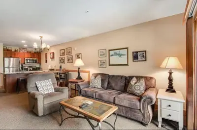 a living room with a couch and a table at 1 Bedroom Colorado Mountain Vacation Rental In River Run Village With Convenient Access To Ski Slopes in Snake River Health Services Incorporated Heliport