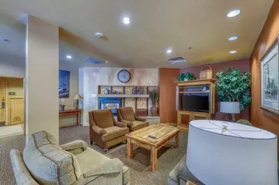 a living room with a couch chairs and a tv at 1 Bedroom Mountain Condo In River Run Village With Beautiful Mountain Views And Walking Distance To Ski in Keystone