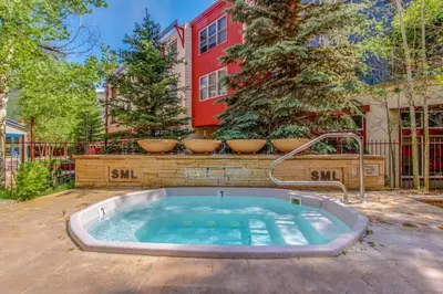 a hot tub in the backyard of a house at 1 Bedroom Mountain Condo In The Heart Of River Run Village Within Walking Distance To Ski in Keystone