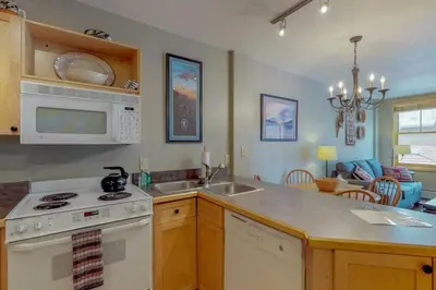 a kitchen with a sink and a stove top oven at 1 Bedroom Mountain Condo In The Heart Of River Run Village Within Walking Distance To Ski in Keystone