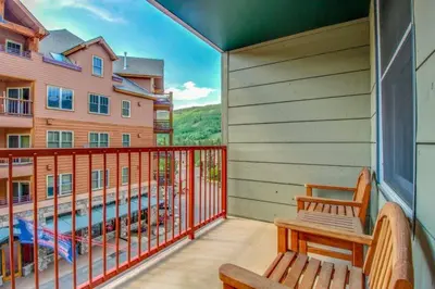 a balcony with a bench and a view of a building at 1 Bedroom Mountain Condo In The Heart Of River Run Village Within Walking Distance To Ski in Keystone