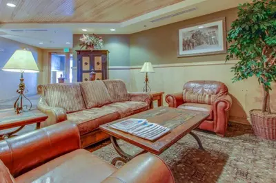 a living room with leather furniture and a table at 1 Bedroom Mountain Condo In The Heart Of River Run Village Within Walking Distance To Ski in Keystone
