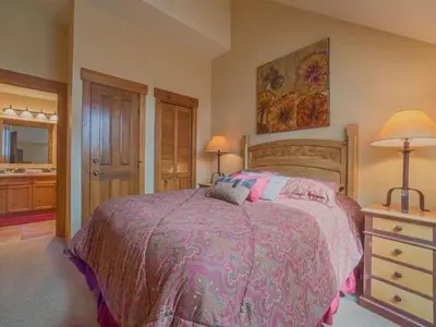a bedroom with a bed and a dresser with two lamps at 2 Bedroom Colorado Vacation Rental Situated In River Run Village Steps From The Summit Express Gondola in Keystone